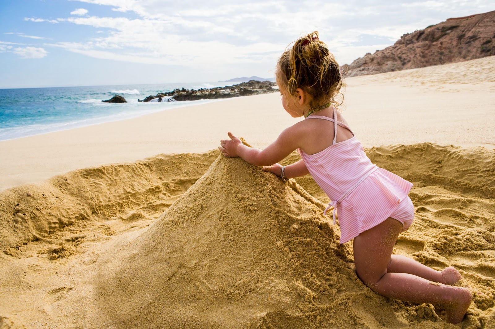 Young Girl Playing in Sand