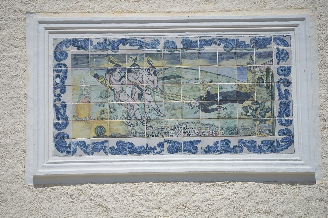 Mural of San Jose del Cabo - a tile on a church depicting a historic scene.