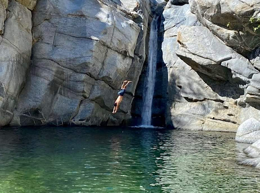 Men diving in front of Fox Canyon Waterfall