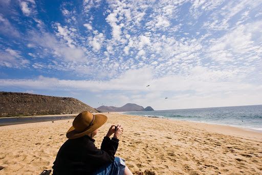 Female taking picture at the todos Santos beach